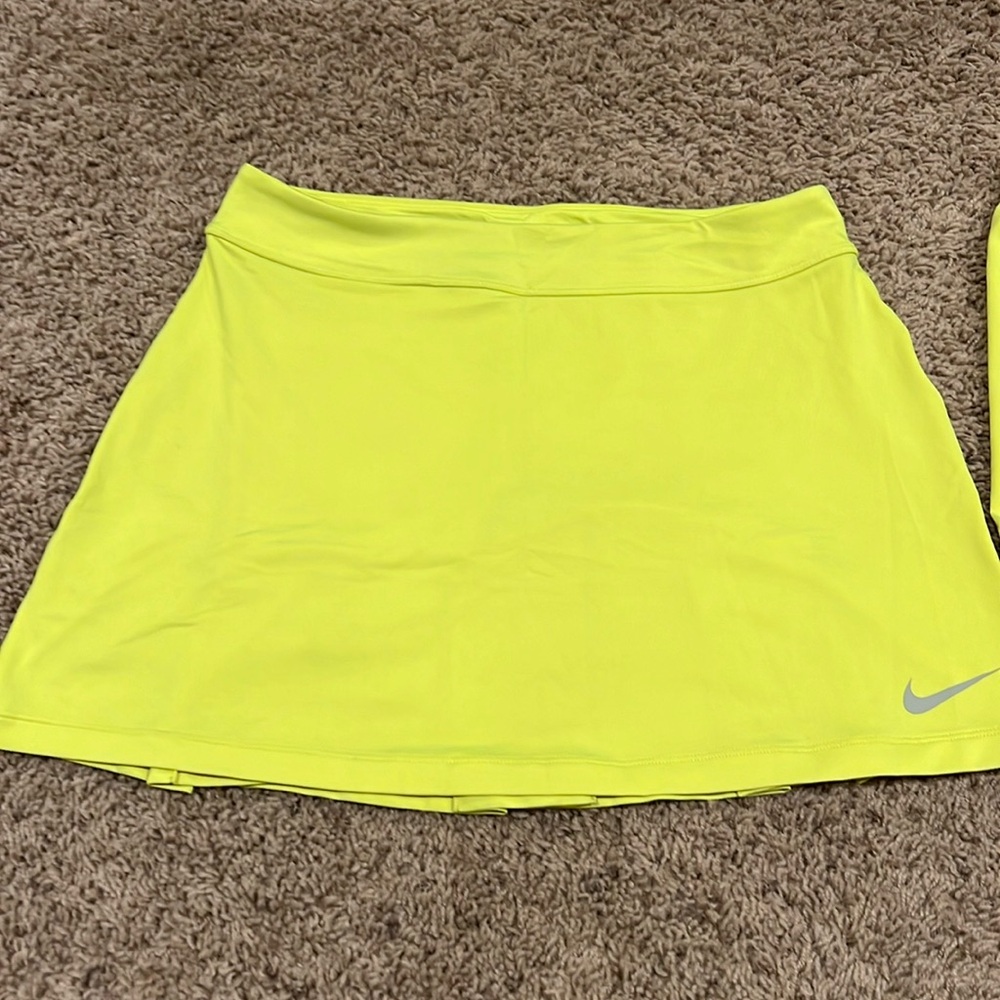 Women's Nike Dri-fit golf skirt with separate matching compression shorts.
